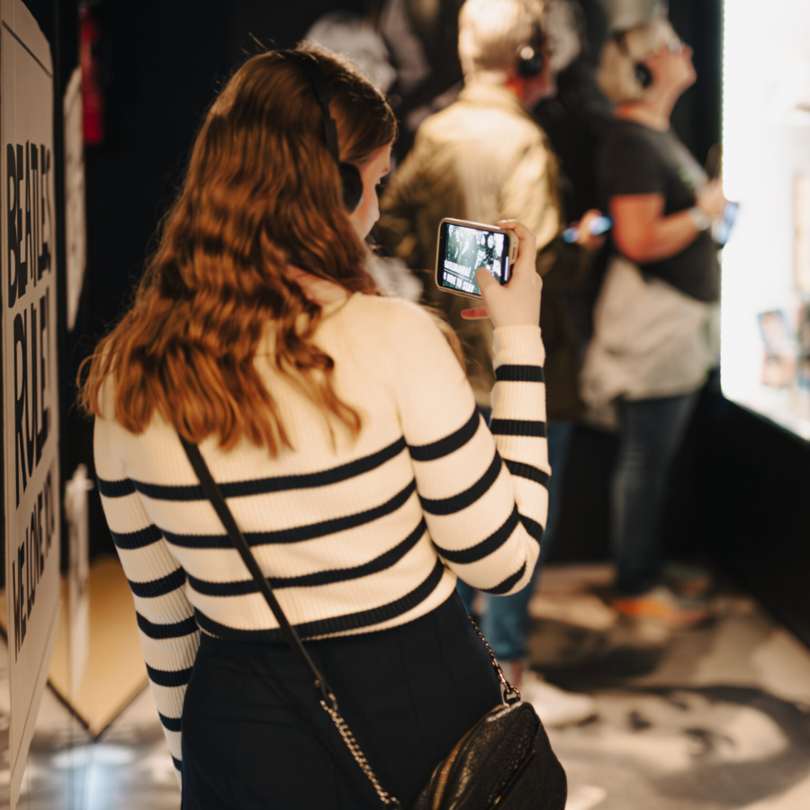 Visitor taking pictures inside The Beatles Story Museum in Liverpool
